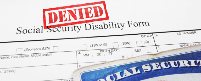 red denied social security documents with a social security card